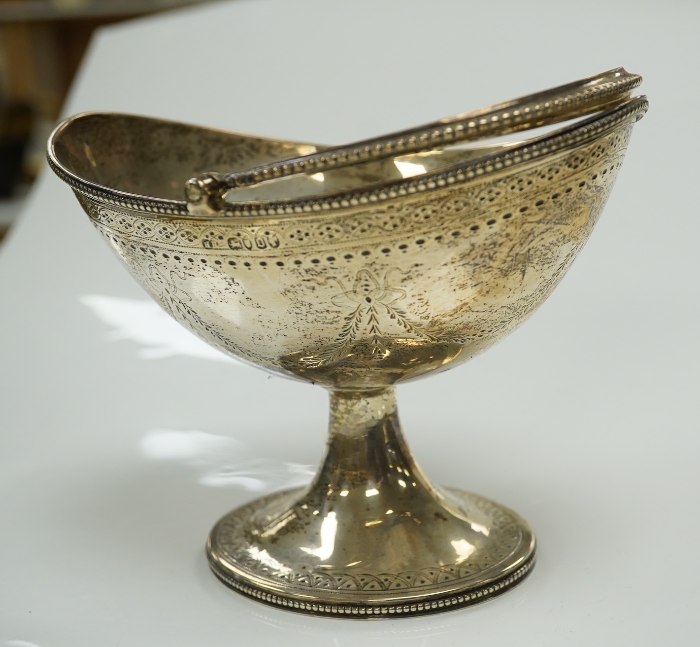 A Victorian engraved silver oval pedestal sugar basket, Henry Holland, London, 1869, width 15.5cm, 7.3oz. Condition - poor